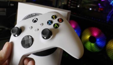 Holding Xbox wireless controller in front of Xbox Series S and desktop PC