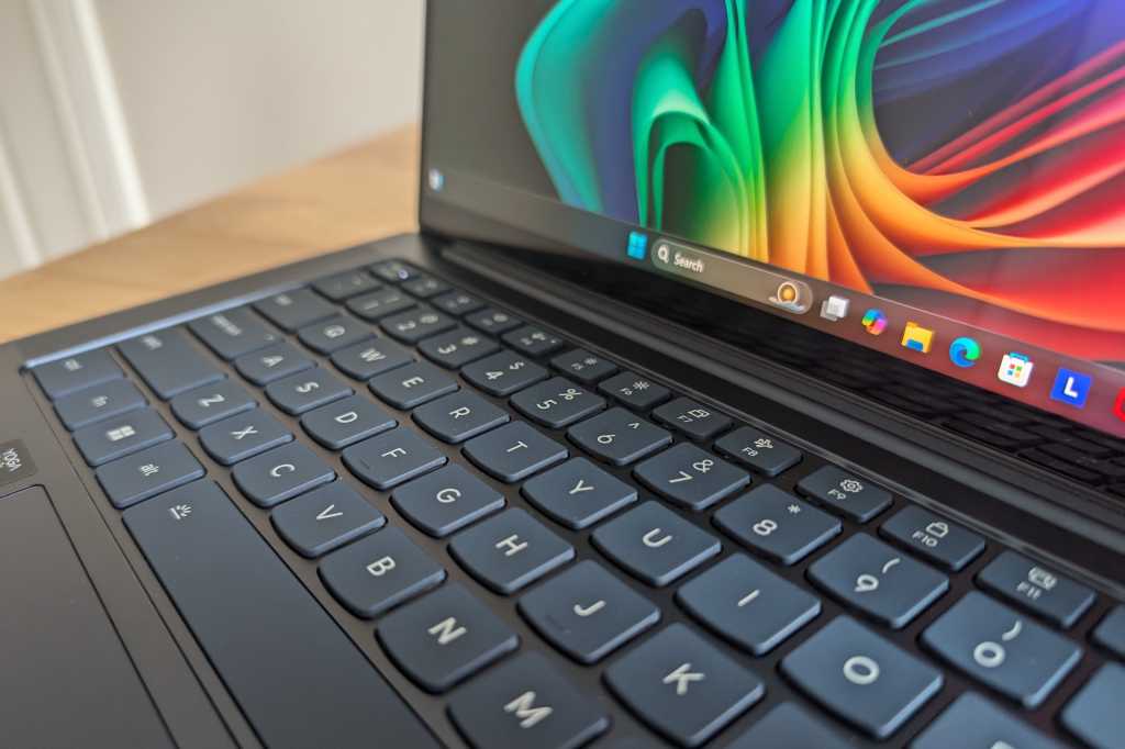 Lenovo Yoga Slim 7x keyboard and display closeup with Windows 11 taskbar