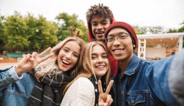 Två tjejer och två killar i tonåren ler mot kameran.