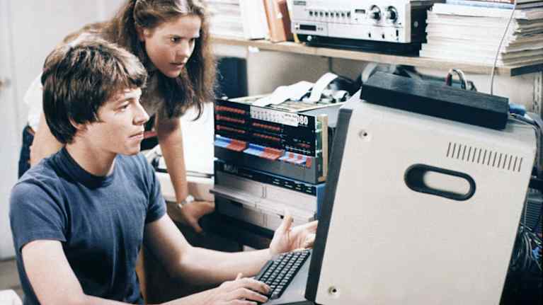 En man och en kvinna sitter framför en dator.