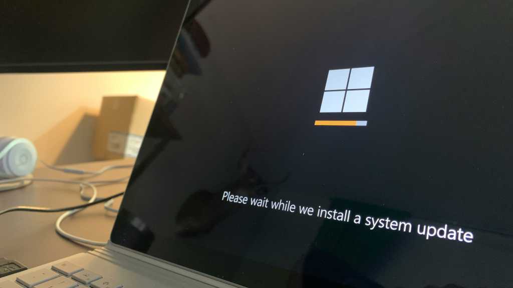 Windows 11 system update message on a laptop screen