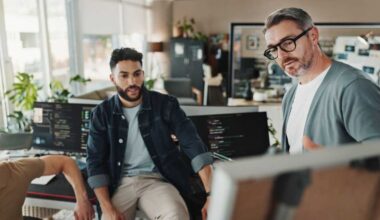 Programmer, teamwork and presentation with business people in office for website developer, coding and review. Mentor, collaboration and software engineer with group of employees in tech startup