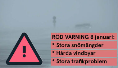 Kraftigt snöoväder med snö som blåser över en väg. Röd varningsskylt med ett utropstecken.