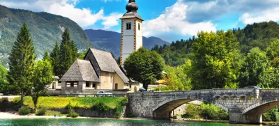 Bohinj Lake, Church of St John the Baptist with bridge. Triglav National Park, Julian Alps, Slovenia.