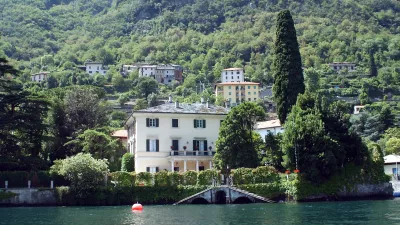 ** FILE ** A lakeside view of George Clooney's villa Oleandra in Laglio, on Lake Como, northern Italy, on July 8, 2004. U.S. film star George Clooney has joined a protest to stop construction of parking lots and a promenade in the northern Italian lakeside town where he owns a villa because he fears his presence is turning the quiet town into a tourist attraction, Friday, July 22, 2007.. (AP Photo/Antonio Calanni, files)