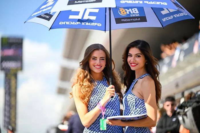 The BK8 Gresini umbrella girls in pit lane.