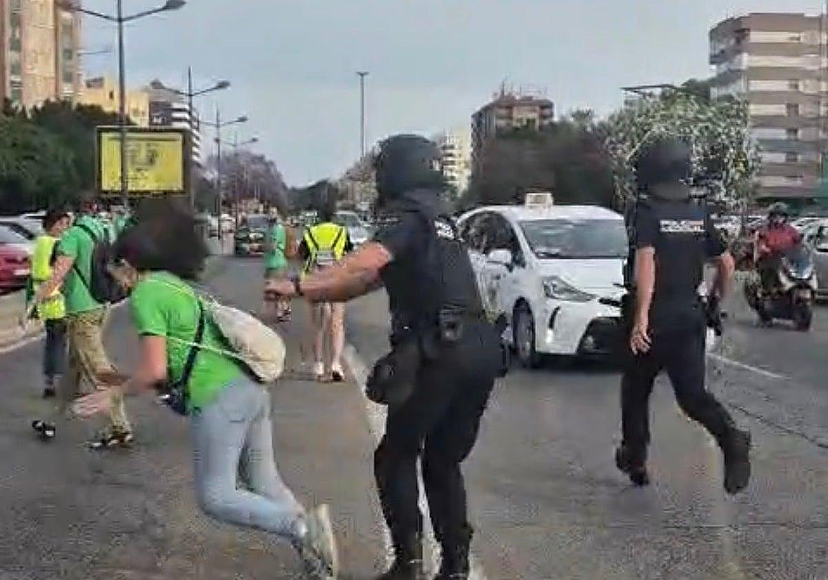 Moment riot policeman shoves retired teacher, 68, to the ground at Spanish protest, sparking internal probe
