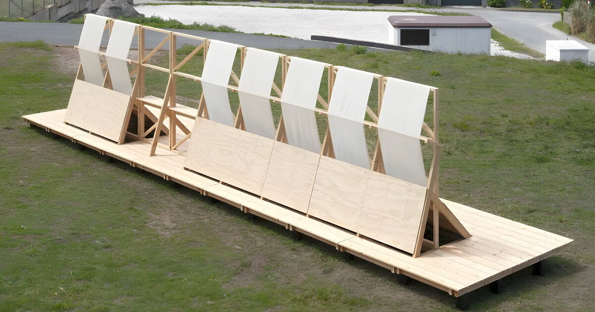 diagonal timber wall becomes furniture, shelter, and landscape frame in spain