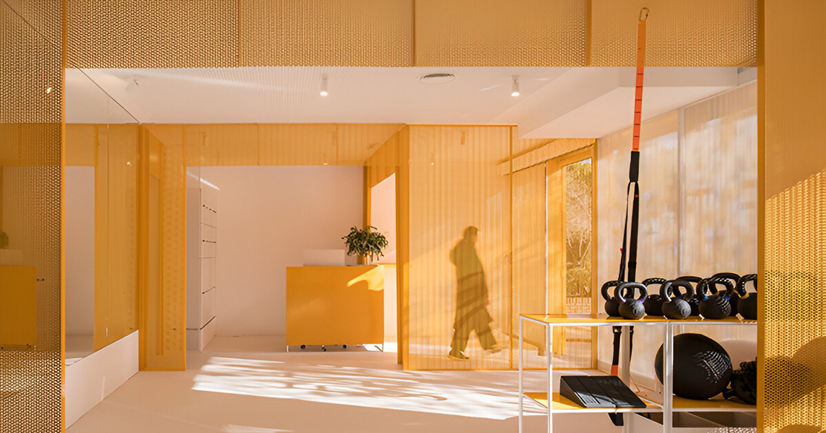 bright orange perforated metal sheets shape a modular fitness center in madrid