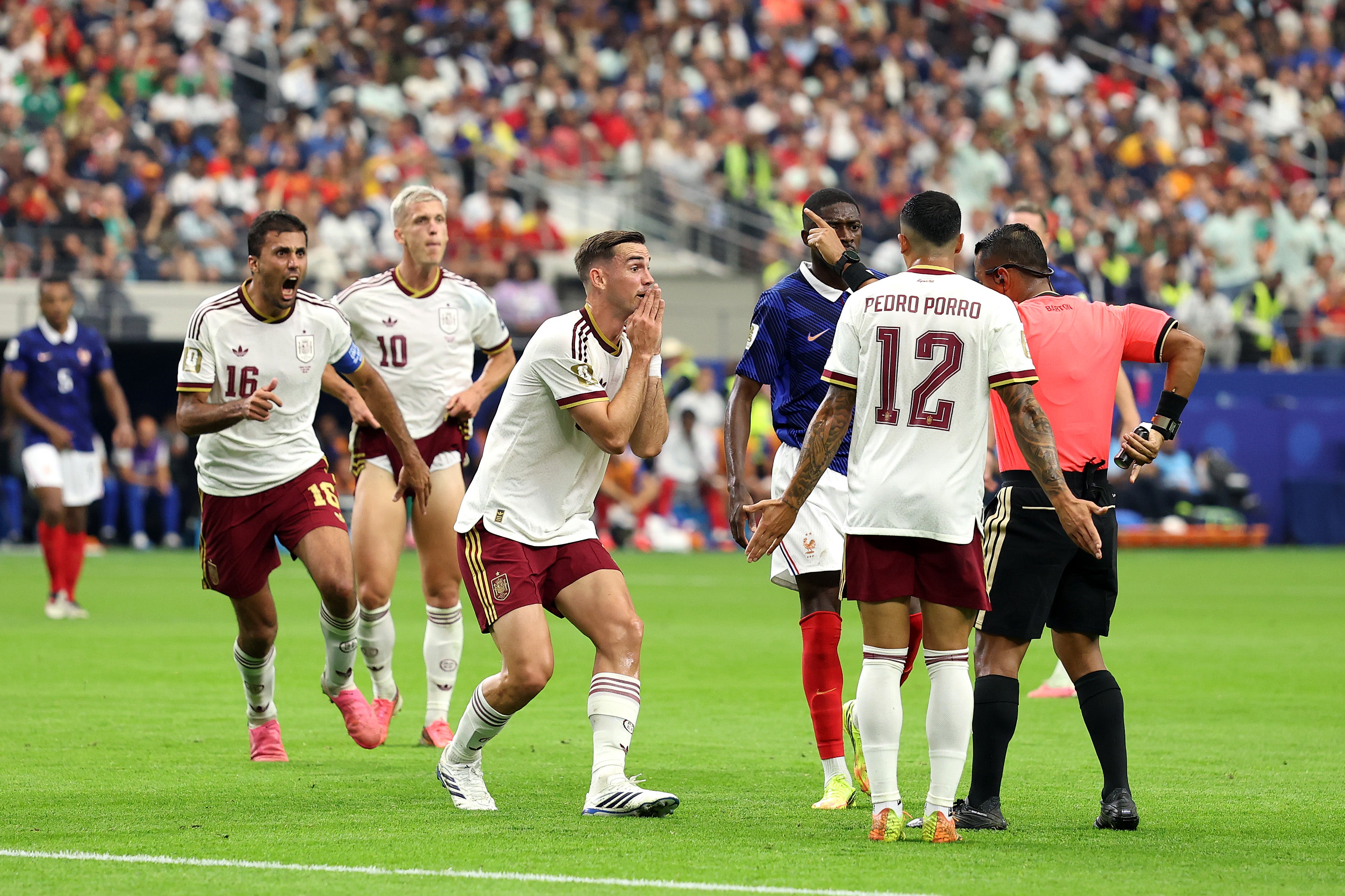 Fabian Ruiz #8 of Spain argues a call with referee Ivan Barton