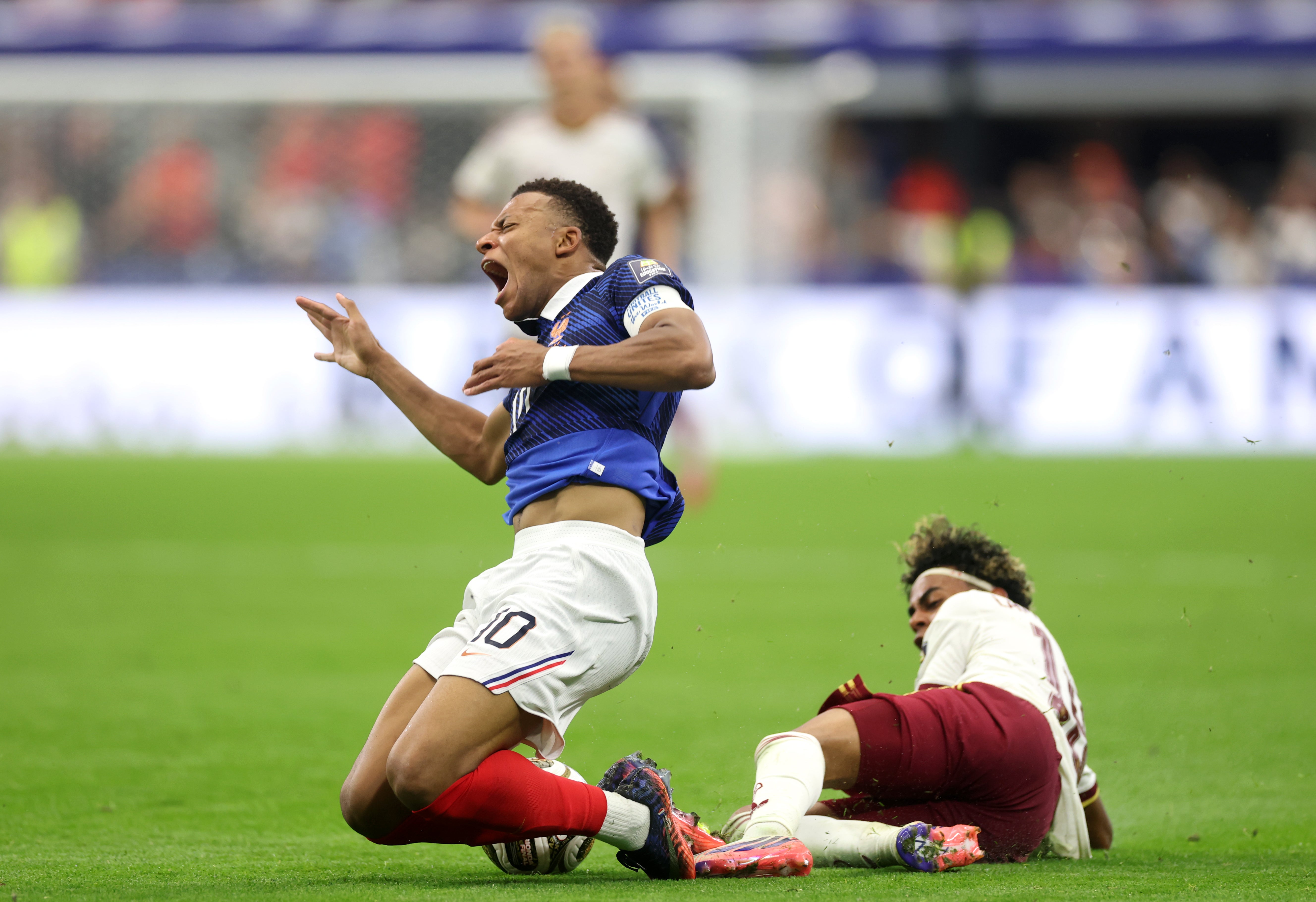 Kylian Mbappe of France competes for the ball against Lamine Yamal of Spain