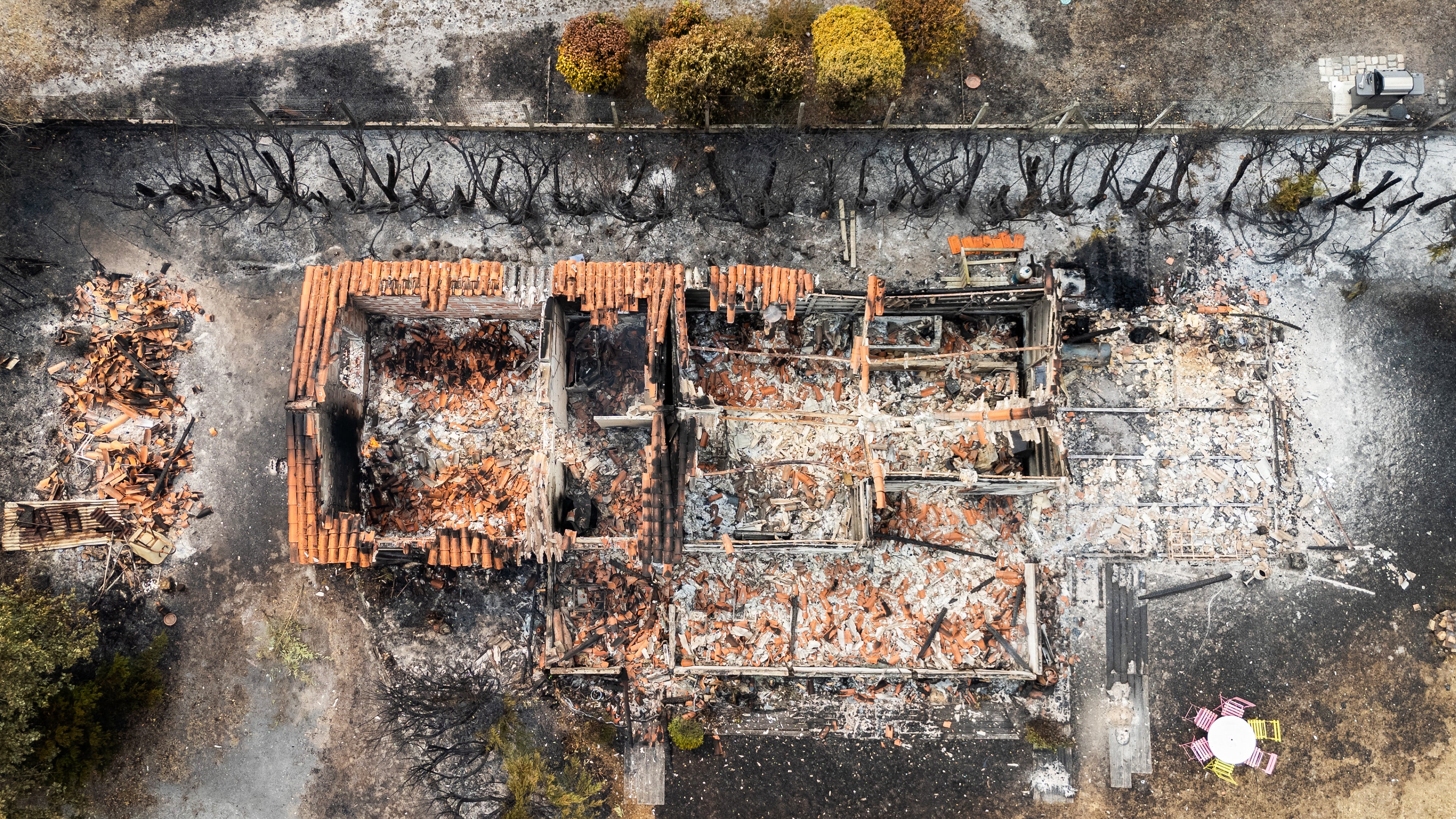 This aerial view shows a burnt building following a wildfire in Le Porge, in the Gironde Department, south-western France on July 25, 2026.