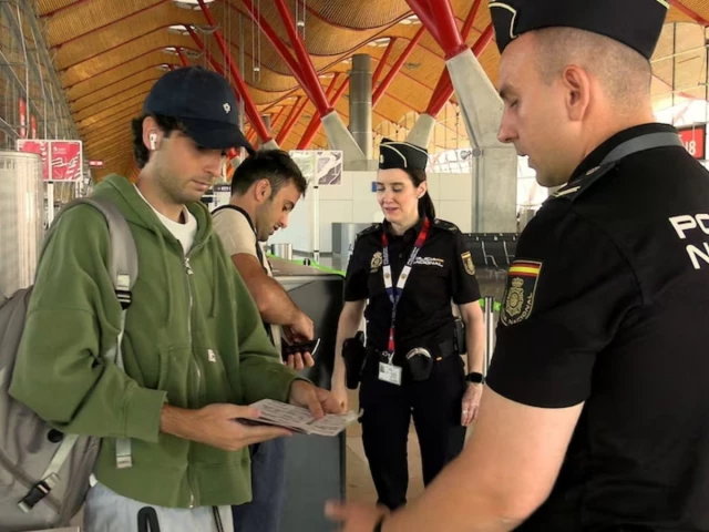 spanish national police officers check the documents of travellers arriving from italy after spain s government said it would establish border controls for flights and ships from italy until september 7 in a dispute over irregular migration at madrid barajas airport in madrid spain august 8 2026 photo reuters