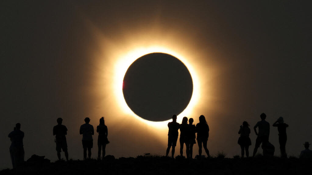 Millions gather to watch as solar eclipse plunges swathe of Spain into darkness