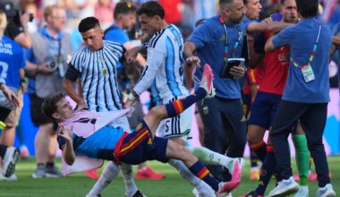 Argentina's Leandro Paredes (5) knocked down Spain's Gavi (9) as Argentina coaches (right) scuffled with Spain's Eric García (4) after the World Cup final.