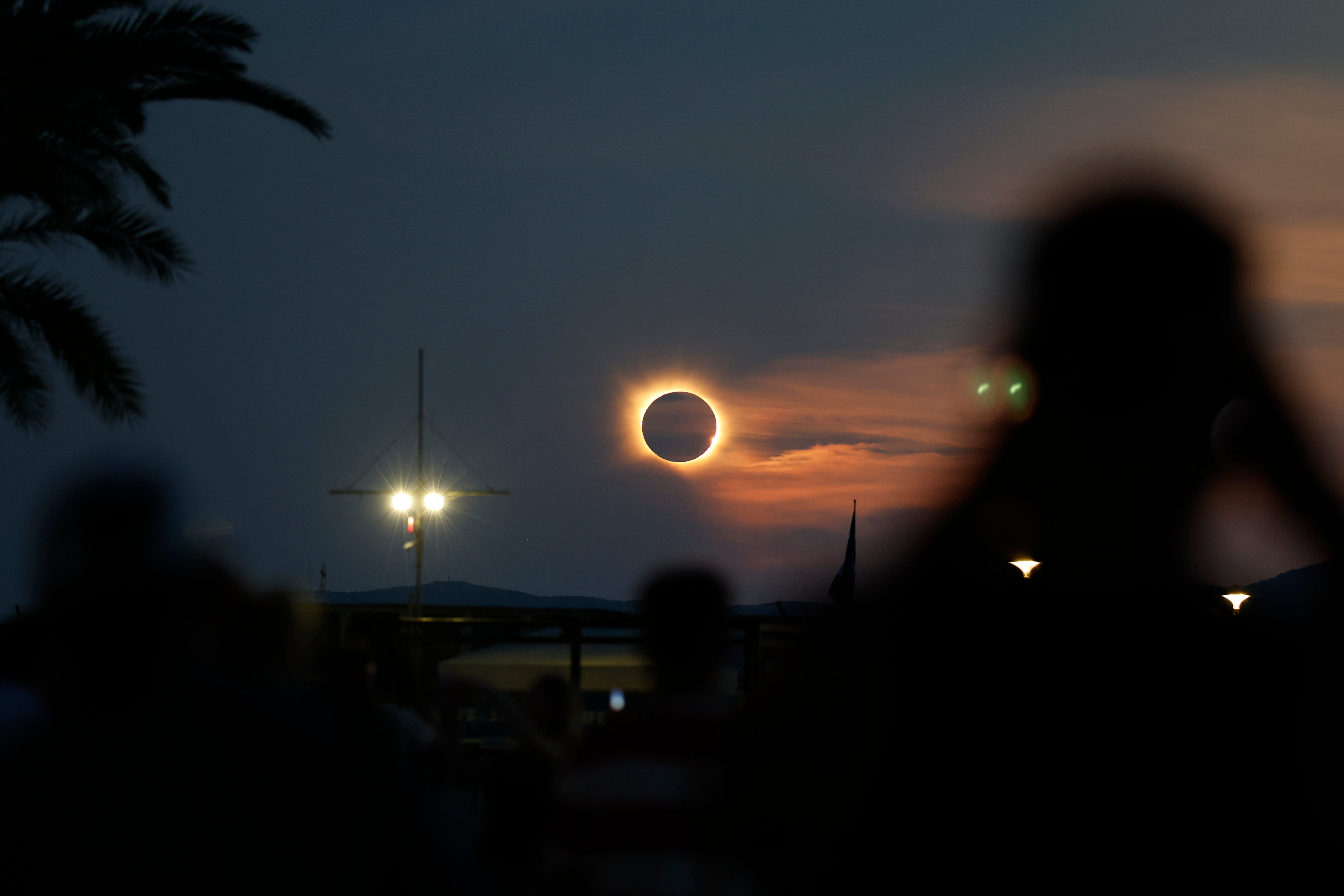 The sun's corona glows as the moon completely blocks the sun during the totality phase of the total solar eclipse as seen from Arenal beach in Llucmajor, on the Balearic island of Mallorca
