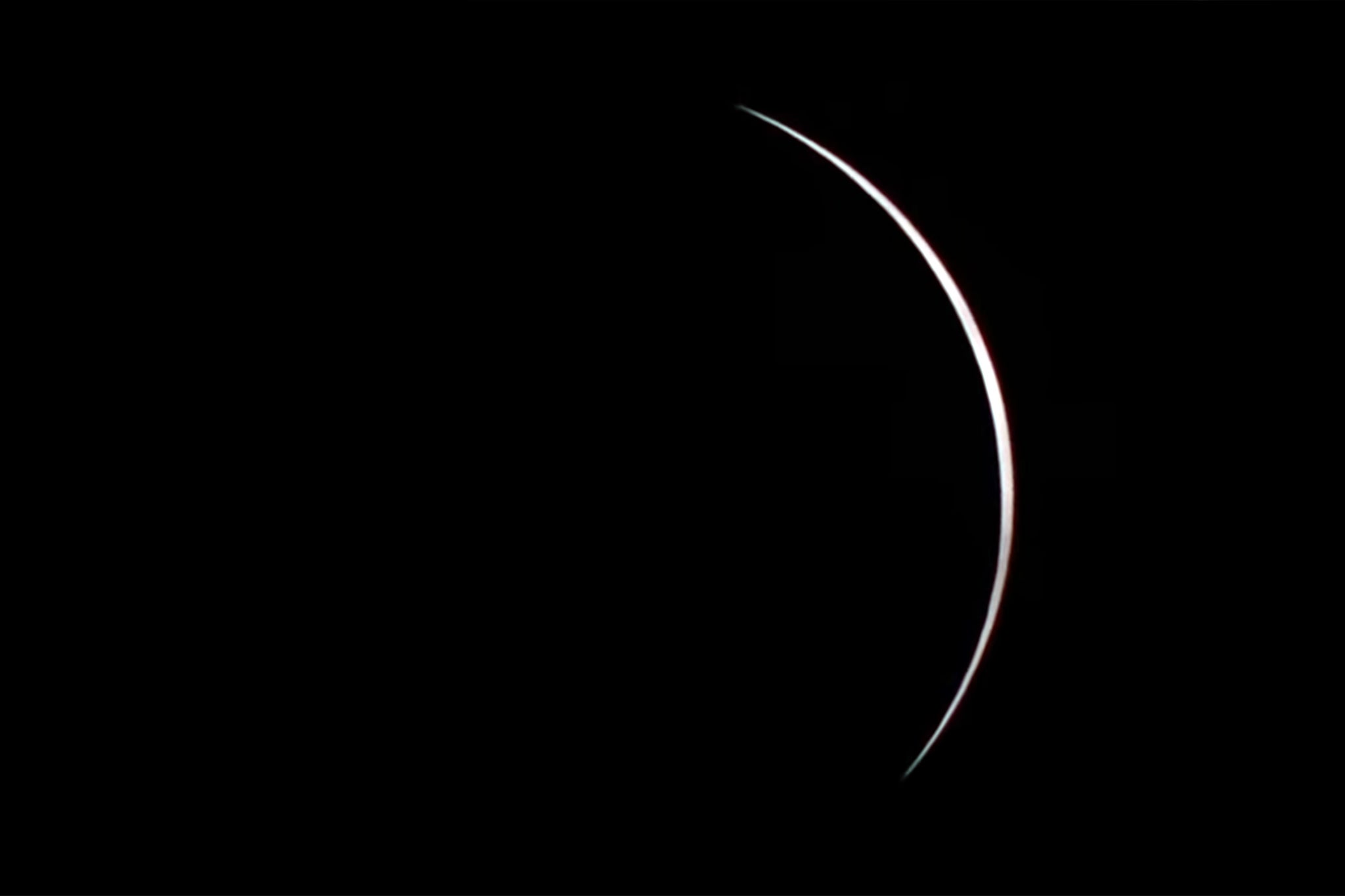 The sun emerging from the side of the moon after the total eclipse in Iceland