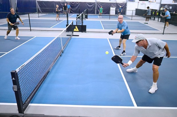Former professional tennis player Ivan Lendl, bottom right plays pickleball with former UConn tennis coach Glenn Marshall, top left, and Scott Trevethan of Berlin, top right, in Plainville, Conn., Thursday, Aug. 13, 2026. (Jessica Hill/Special to the Courant)