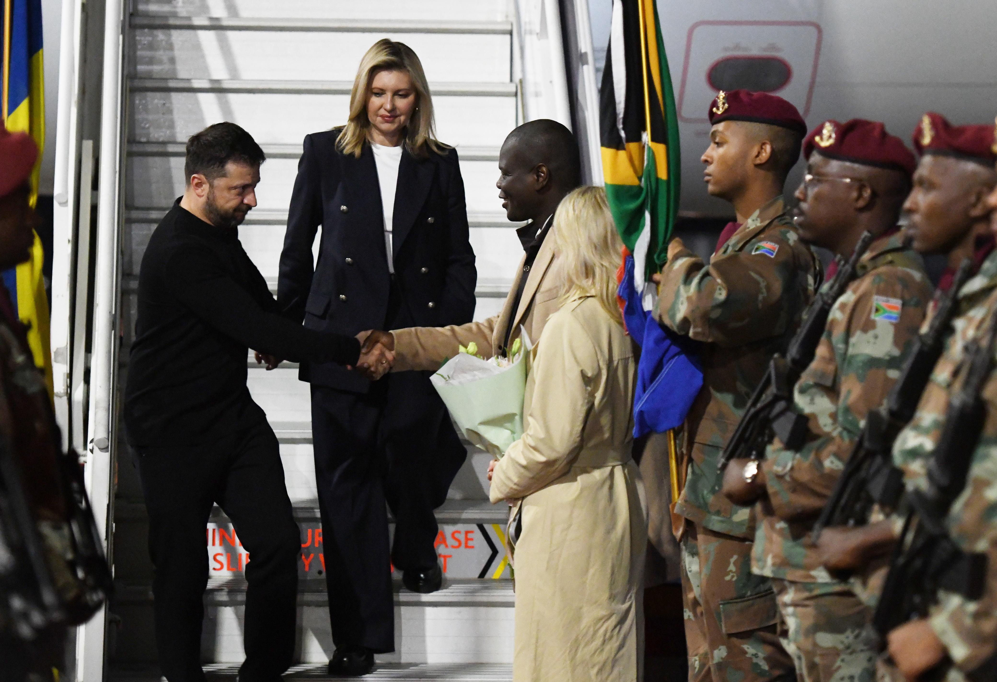 President Zelensky and his wife Olena are greeted as they arrive in South Africa on Thursday