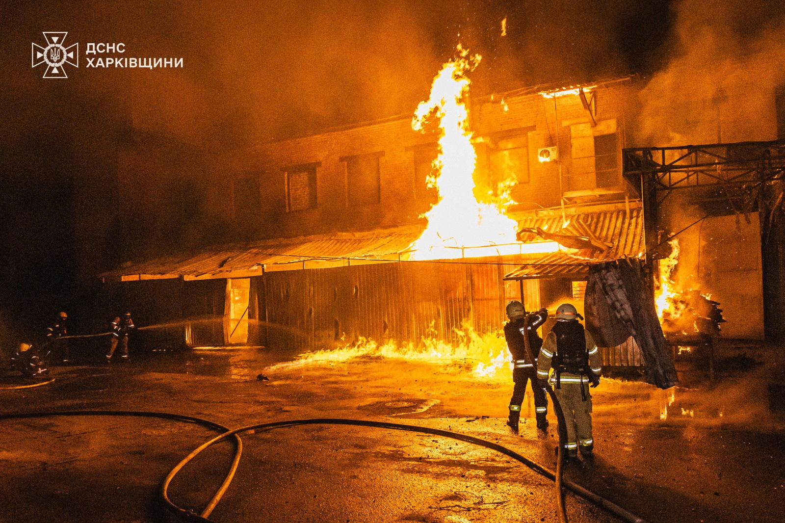 Firefighters at the site of a Russian attack in Kharkiv