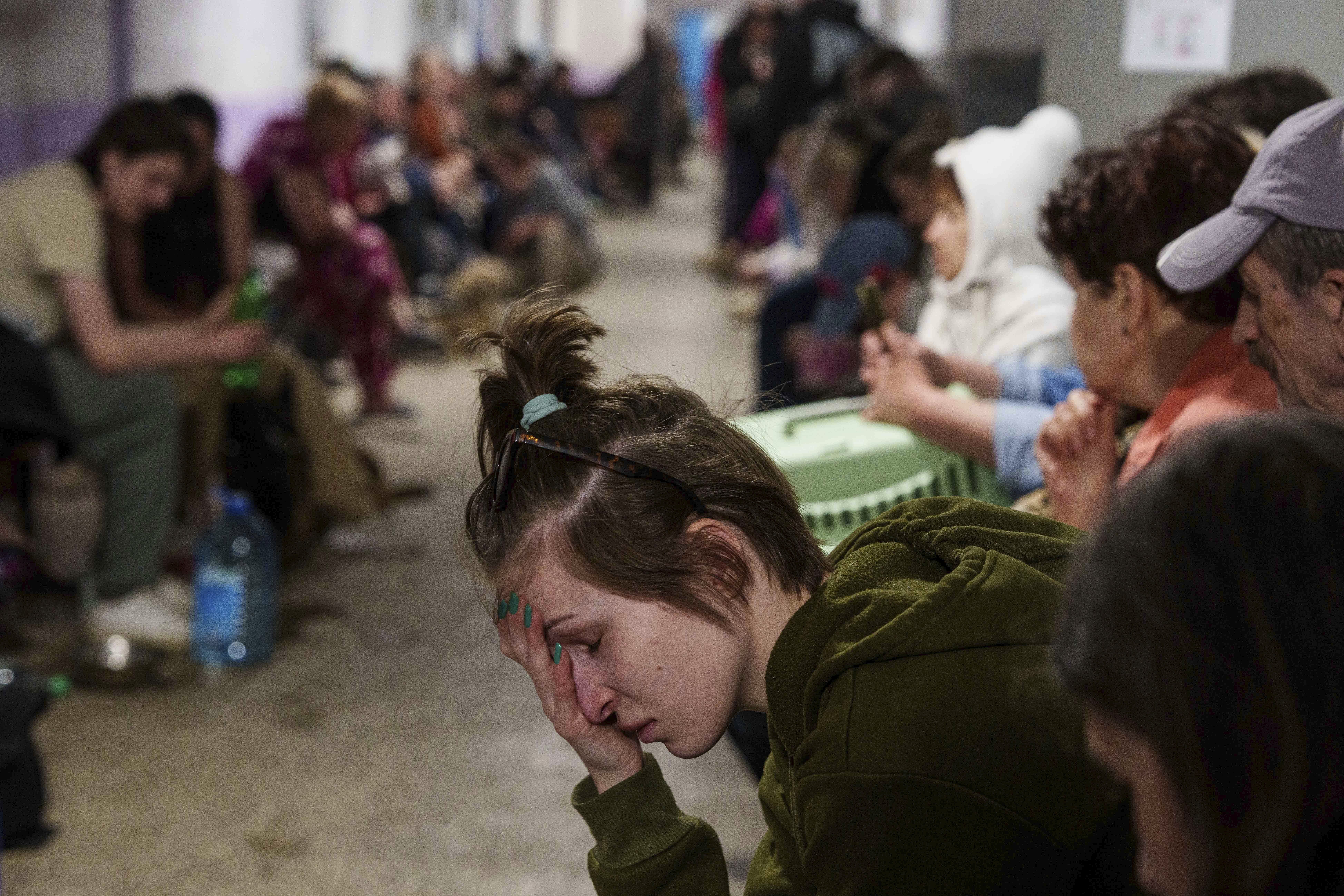 A woman sits in a school basement