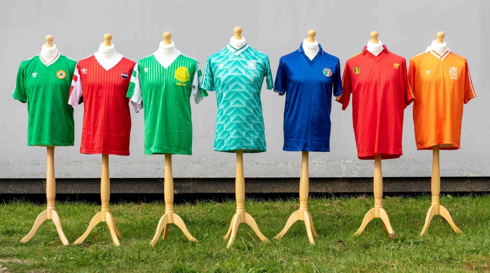 Seven 1990 World Cup soccer jerseys on display.