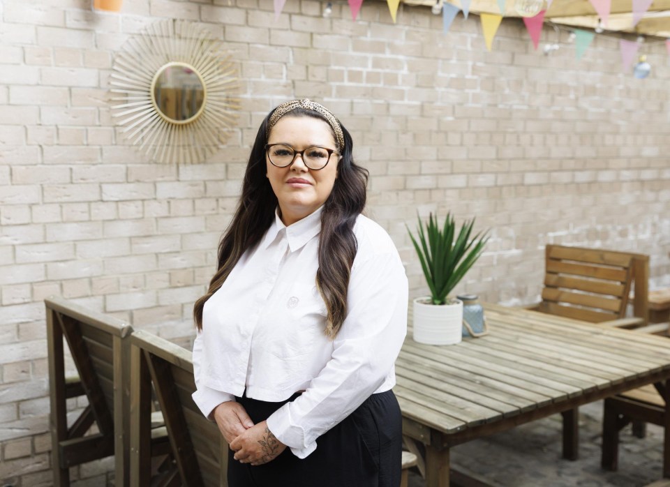 Portrait of Jacqueline McCaig, a pub owner, standing in her outdoor patio area.