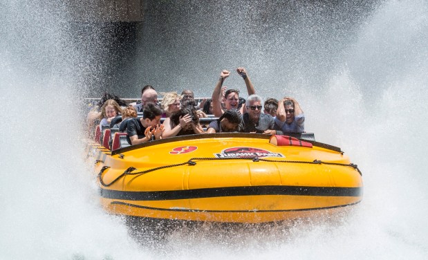 Visitors take cover as they hit the water on Jurassic Park The Ride at Universal Studios Hollywood in Universal City on Friday, June 30, 2017. (Photo by Ed Crisostomo, Los Angeles Daily News/SCNG)