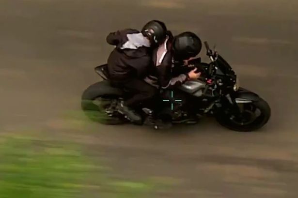 Jack Fagan driving the motorcycle with his pillion passenger, Connor Mitchell.