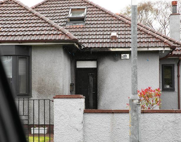 The walls of Norman's home are smoke stained after the blaze while parts of the roof and door are seen to be melted