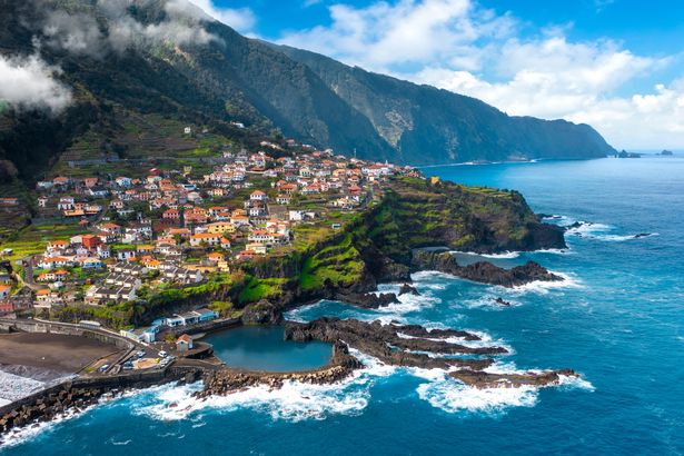 Aeral view of blue clear skies, seaside, mountains and buildings
