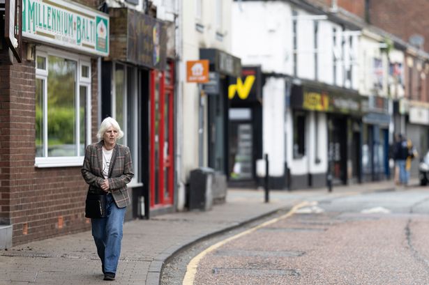 A woman walks down Runcorn High Street