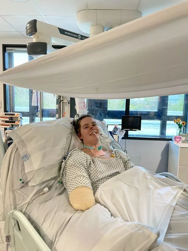A young woman lying in a hospital bed
