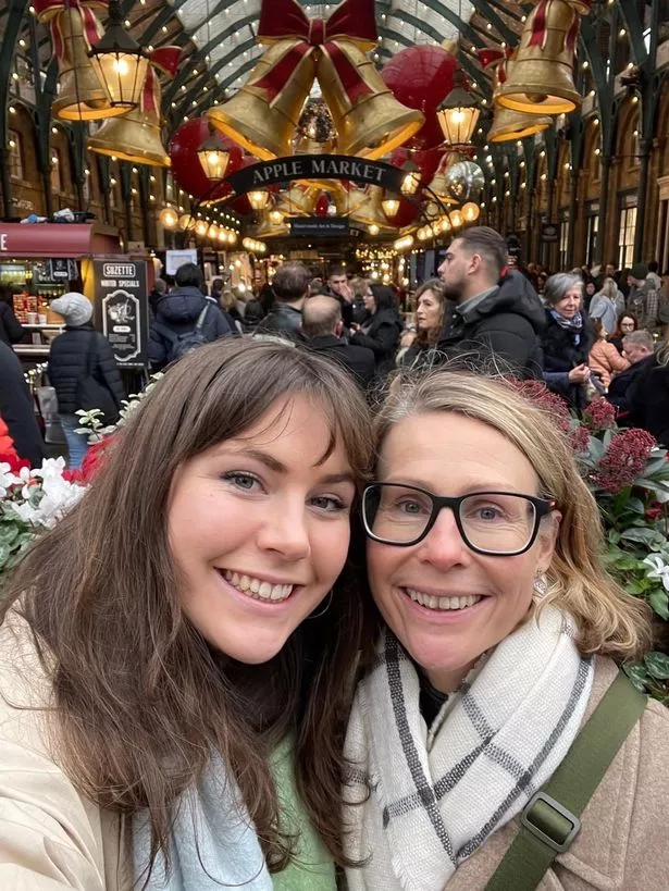 A selfie of a mother and daughter outside a Christmas market