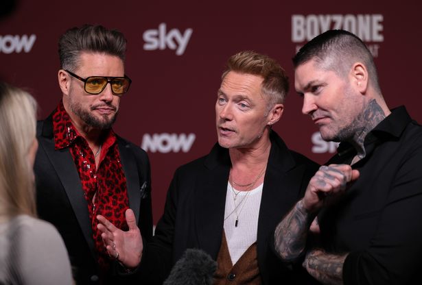 Keith Duffy, Ronan Keating and Shane Lynch being interviewed at the documentary premiere.