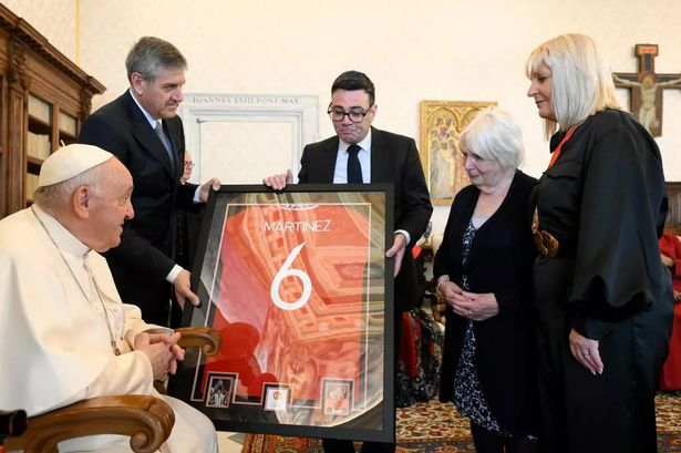 A gift to Pope Francis from 'The Butcher': Martinez's jersey is handed over by Andy Burnham (centre)