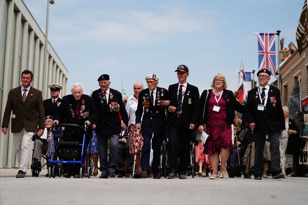Veterans including Alan Kennett (right) arrive for the D-Day and Normandy veterans parade with the Spirit of Normandy Trust on the sea front in Arromanches, in Normandy, France, to commemorate the 80th anniversary of the D-Day landings in June 2024.