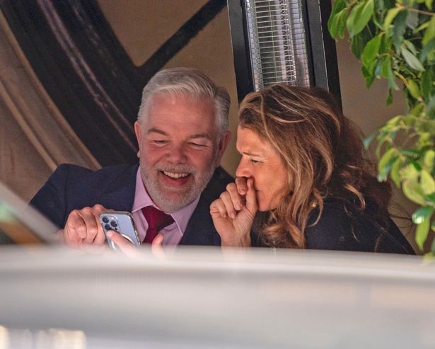 Annabel Croft and Huw Williams appear engrossed in content on his phone while at lunch at Scott's in Mayfair