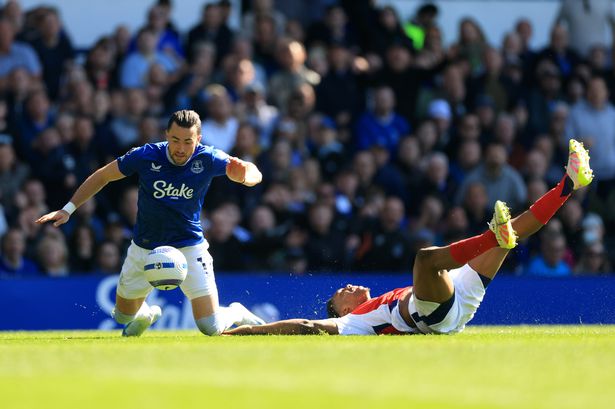 Everton's Jack Harrison goes down under a challenge from Arsenal's Myles Lewis-Skelly