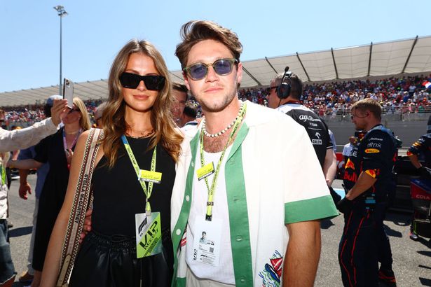 Niall Horan and Amelia Woolley pose for a photo on the grid during the F1 Grand Prix of France at Circuit Paul Ricard