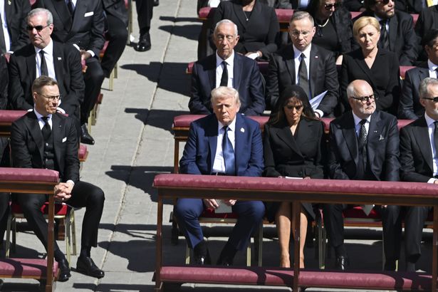 Donald Trump stood out in his light blue suit in a sea of mourners wearing all-black