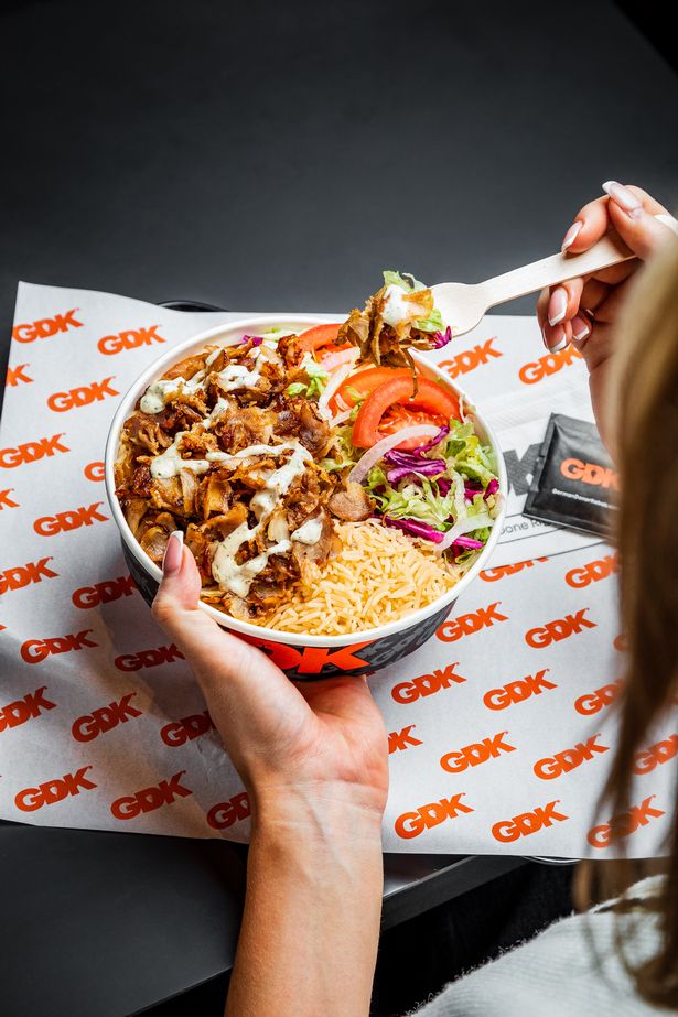 Photo shows person eating rice bowl