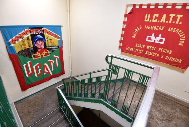 An old construction workers union banner is hung at the top of the main staircase, just before visitors reach the old ventilation control rooms.