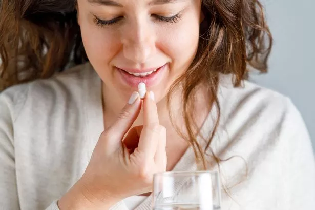Woman taking supplement