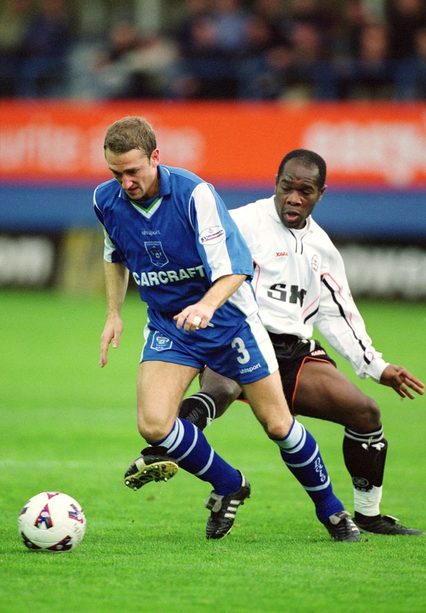 Sean McAuley of Rochdale takes the ball past Adrian Forbes of Luton Town during the Nationwide League Division Three match played at Kenilworth Road in 2001