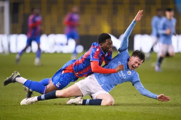 MANCHESTER, ENGLAND - DECEMBER 06: Ben Casey of Crystal Palace is challenged by Kian Noble of Manchester City during The FA Youth Cup Third round match between Manchester City and Crystal Palace at Joie Stadium on December 06, 2024 in Manchester, England. (Photo by Ben Roberts Photo/Getty Images)