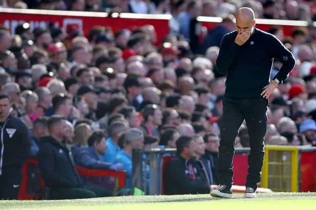Pep Guardiola, manager of Manchester City looks dejected on the sideline during the Premier League match between Manchester United and City