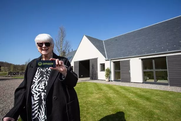 Patricia Moule, Omaze Winner outside her new £4m home in Scotland. 