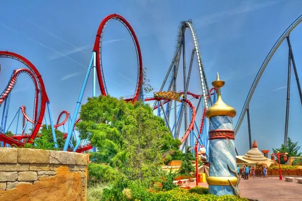 Salou, Spain - July 18, 2015: Dragon Khan and Shambhala attractions in PortAventura,  is a theme park and a resort in the south of Barcelona, in Salou, Tarragona.  It attracts around 4 million visitors per year making it the most visited theme park in Spain and 6th in Europe
