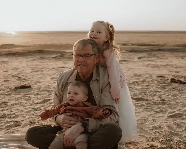 Richard Broddy on the beach with children
